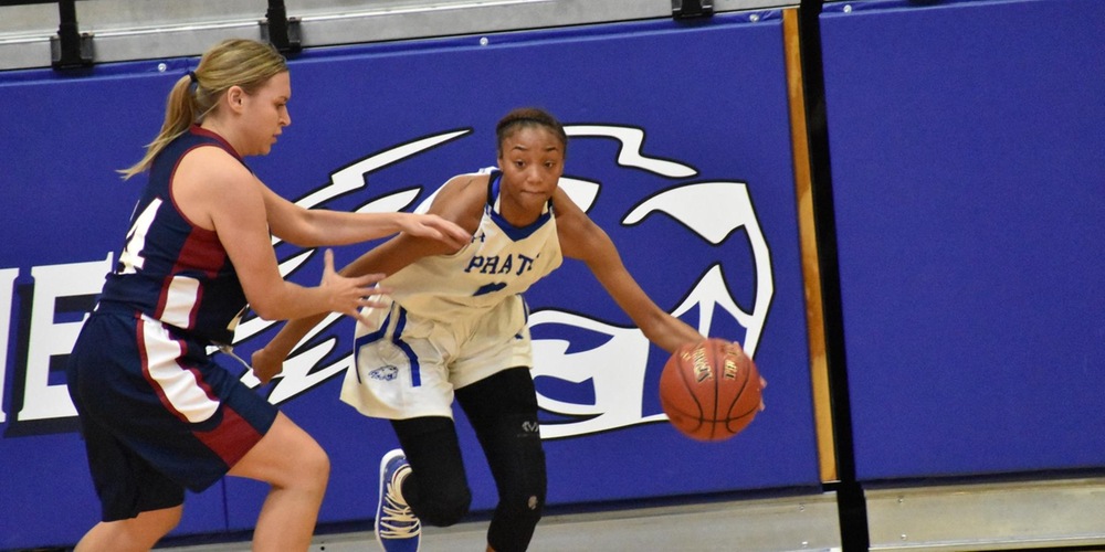 Jazmin George takes the ball up the floor against the Warrior defense.